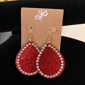 Plunder new shiny red earrings with white reflective trim.